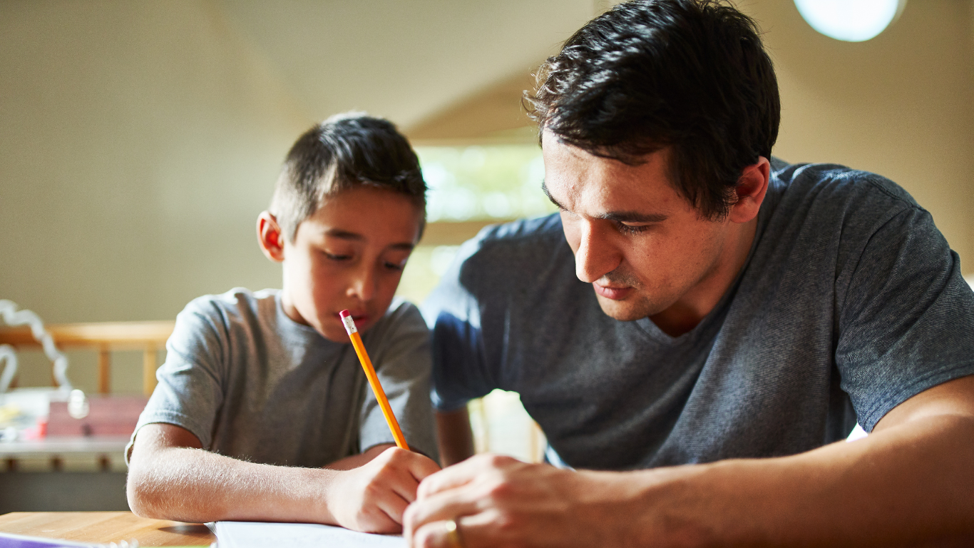 primary child supported in writing exercise.